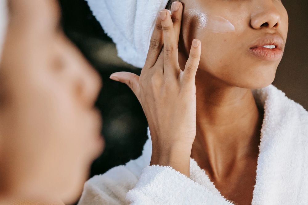 Woman applying skin-care cream